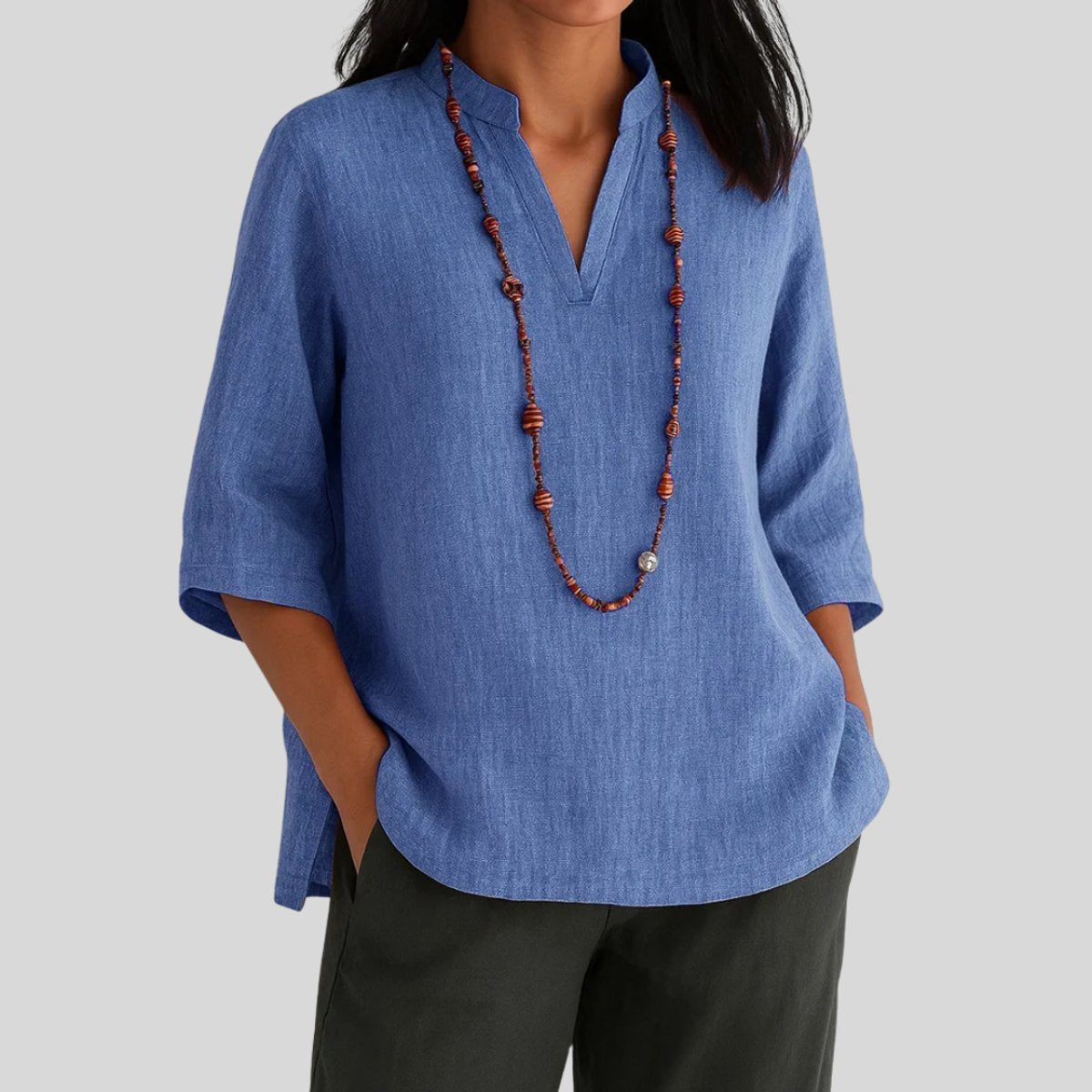 Blusón holgado de lino con escote en V y manga tres cuartos